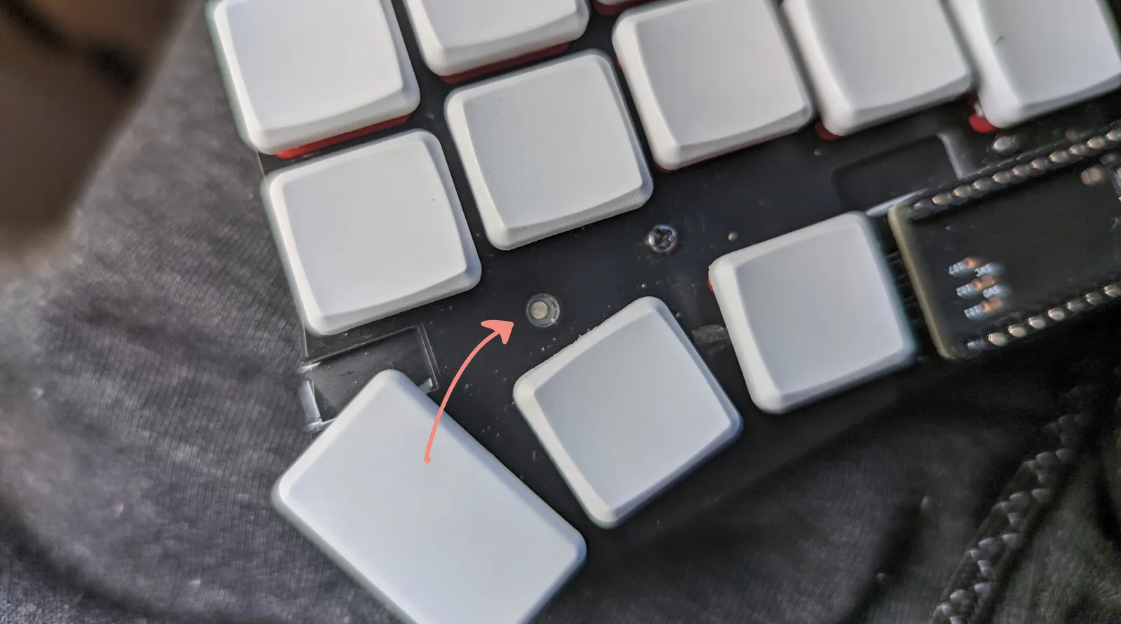 The Microdox keyboard with an arrow pointing where the reset button is