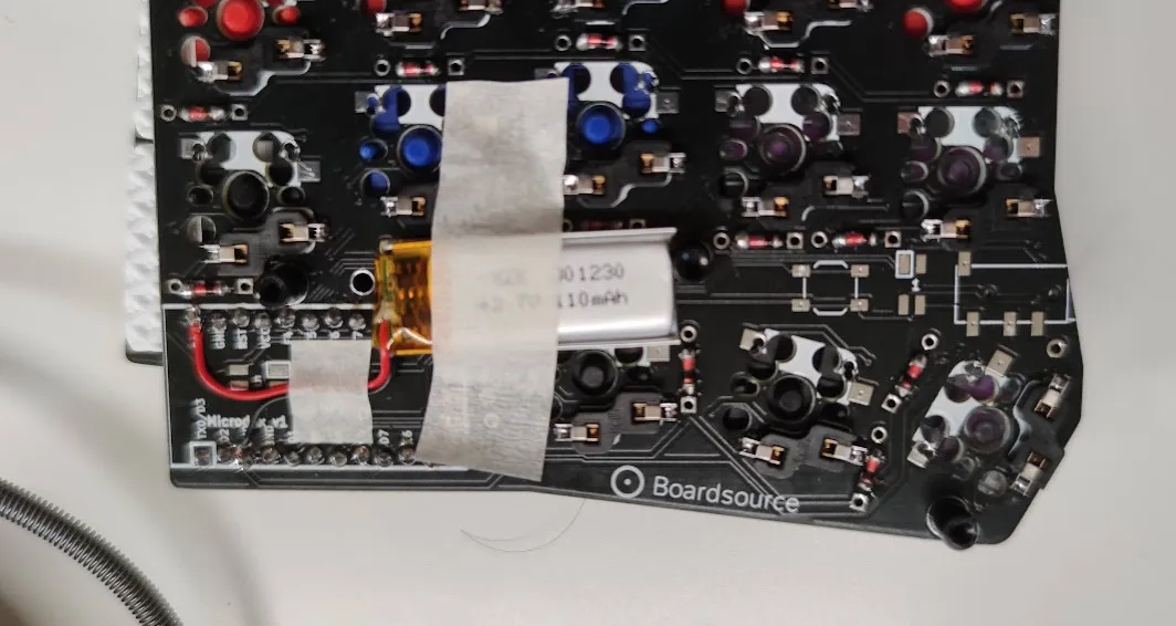 Underside of the keyboard PCB with battery taped to it